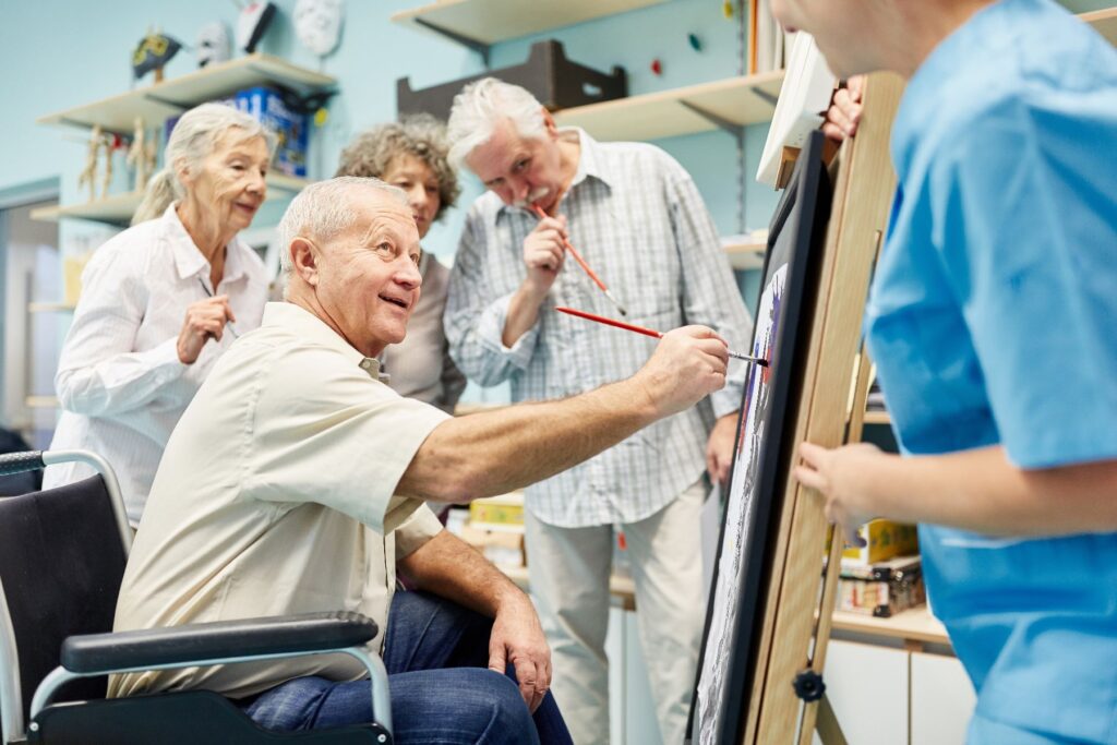 Older adults enjoying a painting class in an independent senior living community in Hendersonville.