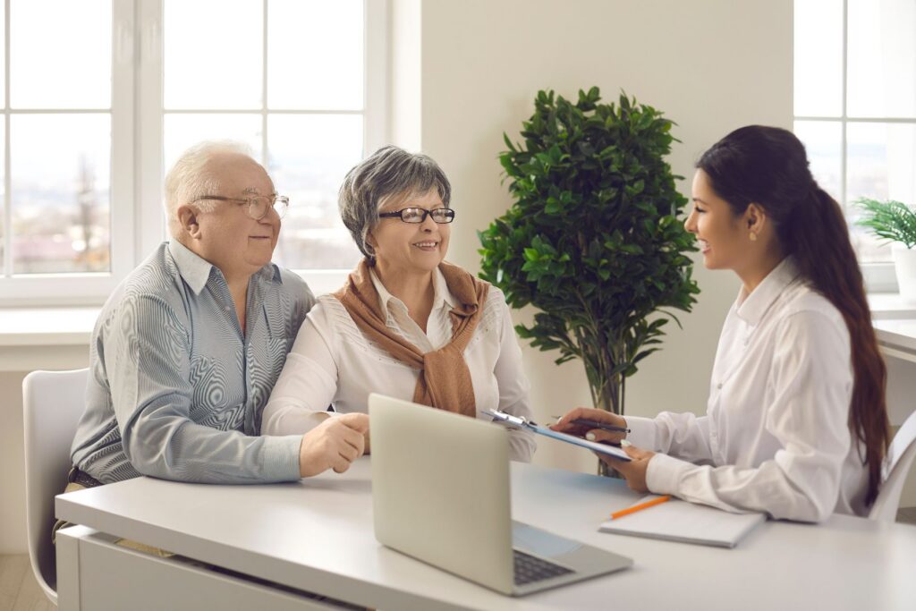 Older adult couple consulting with a professional about Senior Living Vs. In-Home Care